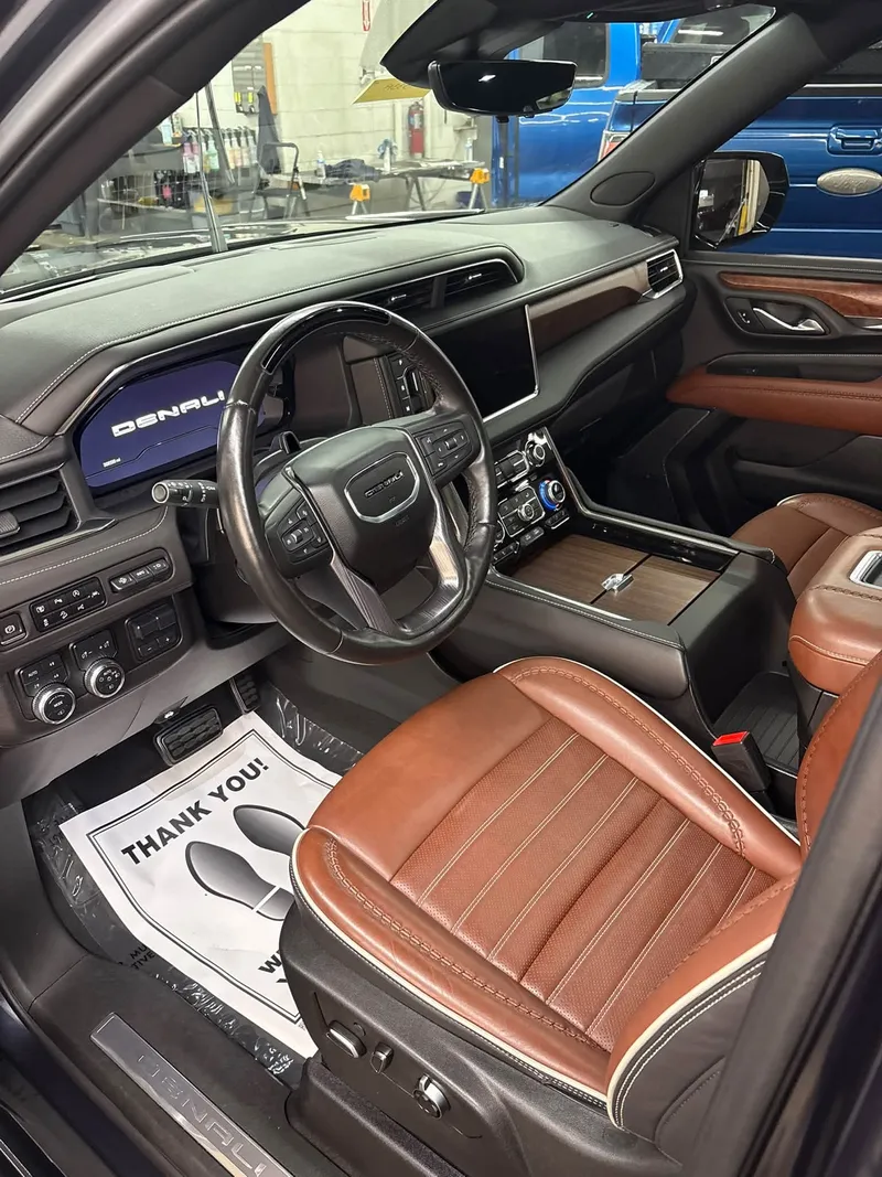 Clean premium SUV dashboard seats and center console after interior detailing