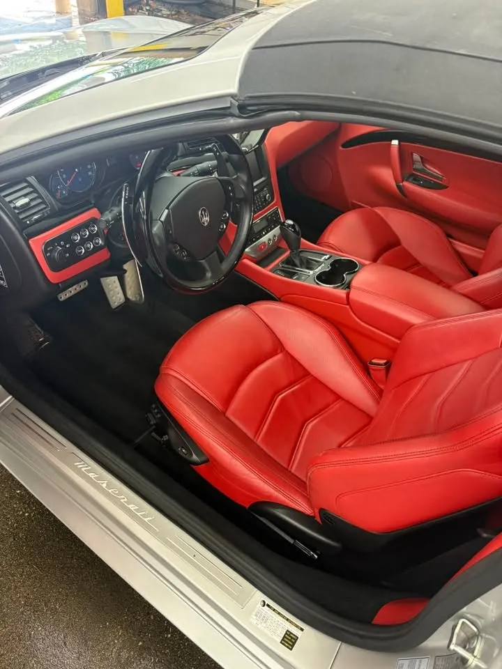 Red leather vehicle interior after professional interior detailing